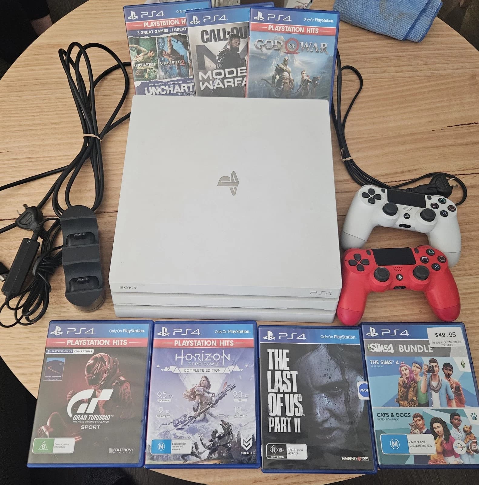 PS4 PRO 1TB White Console 2 Wireless Controllers, Charging Dock & 7 Games - Image 1